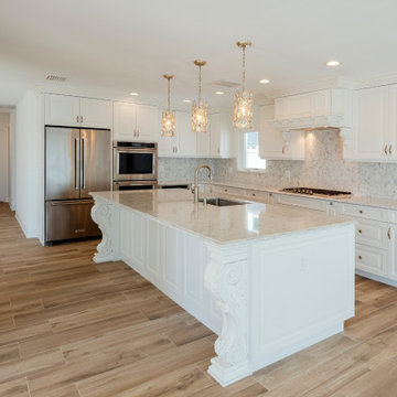 Open-Plan Kitchen With Stacked Shaker Cabinets, Waterfall Island, and Mixed-Mate