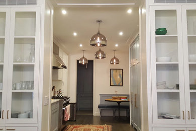 Inspiration for a large transitional galley dark wood floor and brown floor enclosed kitchen remodel in New York with an undermount sink, recessed-panel cabinets, blue cabinets, quartz countertops, white backsplash, subway tile backsplash, stainless steel appliances, no island and white countertops