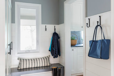 Design ideas for a small traditional mudroom in Minneapolis with blue walls, dark hardwood floors, a single front door and a white front door.