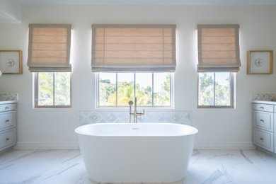 Transitional master double-sink freestanding bathtub photo with a built-in vanity