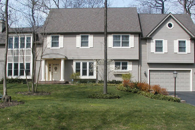 Transitional two-story wood exterior home idea in Chicago with a shingle roof