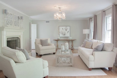 Inspiration for a mid-sized transitional formal and enclosed light wood floor living room remodel in New York with gray walls, a standard fireplace and a brick fireplace