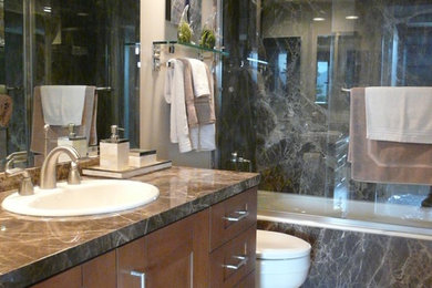Inspiration for a mid-sized contemporary 3/4 gray tile and porcelain tile beige floor bathroom remodel in Los Angeles with shaker cabinets, dark wood cabinets, a one-piece toilet, white walls, a drop-in sink and a hinged shower door
