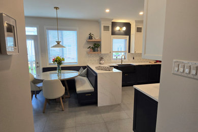 Example of a large transitional u-shaped porcelain tile and blue floor open concept kitchen design in Ottawa with a farmhouse sink, recessed-panel cabinets, blue cabinets, quartz countertops, multicolored backsplash, porcelain backsplash, stainless steel appliances, a peninsula and white countertops