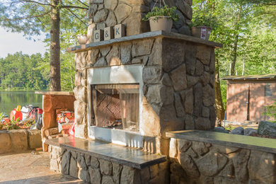 Large transitional backyard stone patio photo in Philadelphia with a fire pit and a pergola