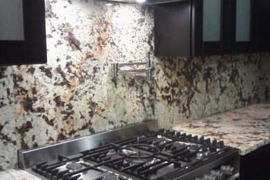 Example of a kitchen design in St Louis with medium tone wood cabinets, granite countertops and white appliances