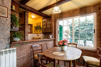 This is an example of a mid-sized country kitchen/dining combo in Other with beige walls, ceramic floors and brown floor.