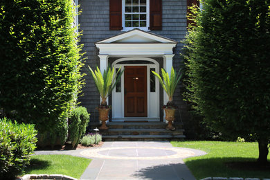Photo of a mid-sized traditional partial sun side yard brick landscaping in New York.