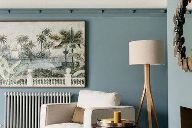 Design ideas for a medium sized modern living room in Cardiff with blue walls, dark hardwood flooring, a standard fireplace, a tiled fireplace surround and a dado rail.