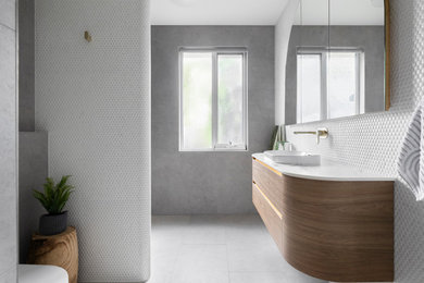 This is an example of a contemporary bathroom in Melbourne with a corner shower, mosaic tile, grey walls, an open shower, a single vanity and a floating vanity.