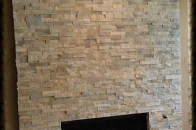 Mid-sized transitional family room in Dallas with travertine floors, a standard fireplace and a stone fireplace surround.