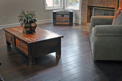 Design ideas for a country family room in San Diego with dark hardwood floors.