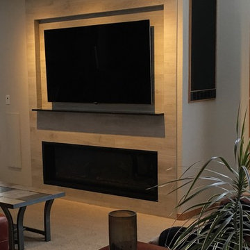 Linear fireplace, tile surround, & recessed gear cabinet