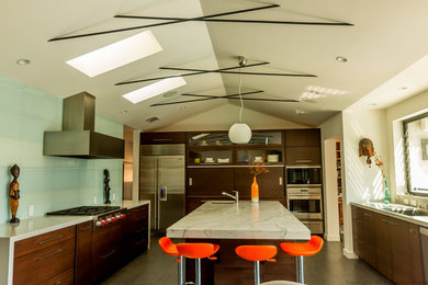 Kitchen pantry - mid-sized contemporary l-shaped kitchen pantry idea in San Francisco with an undermount sink, flat-panel cabinets, medium tone wood cabinets, marble countertops, glass sheet backsplash, stainless steel appliances and an island