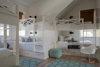 Cette image montre une grande chambre d'enfant marine avec un mur blanc, parquet clair, un sol beige et du lambris de bois.