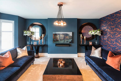Inspiration for a classic formal enclosed living room in Kent with blue walls, carpet, beige floors and a wall mounted tv.
