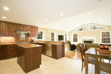 Eat-in kitchen - large traditional ceramic tile and beige floor eat-in kitchen idea in Boston with raised-panel cabinets, medium tone wood cabinets, granite countertops, beige backsplash, stainless steel appliances and an island