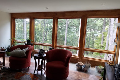 Large brown floor family room photo in Other with white walls, a two-sided fireplace, a tile fireplace and a tv stand