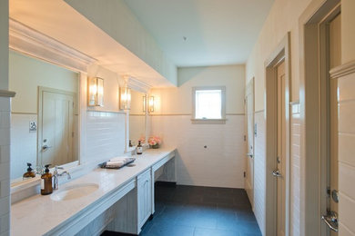 Mid-sized traditional 3/4 bathroom in Philadelphia with recessed-panel cabinets, white cabinets, white tile, ceramic tile, white walls, porcelain floors, an undermount sink, marble benchtops, black floor and white benchtops.