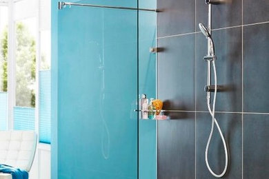 Inspiration for a mid-sized contemporary master black tile and ceramic tile medium tone wood floor walk-in shower remodel in New York with blue walls