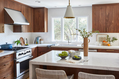 Example of a mid-sized transitional u-shaped light wood floor and brown floor eat-in kitchen design in San Francisco with an undermount sink, flat-panel cabinets, medium tone wood cabinets, quartz countertops, white backsplash, ceramic backsplash, stainless steel appliances, an island and white countertops