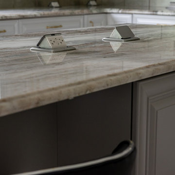 Transitional Kitchen Done in a 2 Tone Color With Integrated Dining Table