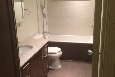 Bathroom - mid-sized contemporary 3/4 single-sink bathroom idea in Other with flat-panel cabinets, brown cabinets, quartzite countertops, white countertops and a built-in vanity