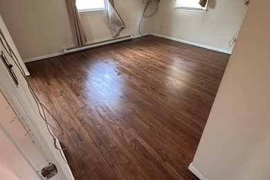Mid-sized dark wood floor bedroom photo in New York