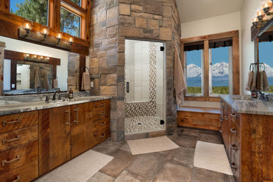 Large arts and crafts master multicolored tile and stone slab slate floor, beige floor, single-sink and vaulted ceiling bathroom photo in Other with flat-panel cabinets, brown cabinets, a one-piece toilet, beige walls, an undermount sink, granite countertops, a hinged shower door, gray countertops and a built-in vanity