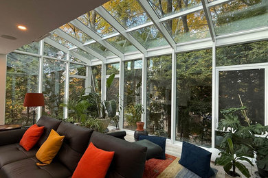 Example of a large trendy gray floor sunroom design in Boston with a glass ceiling