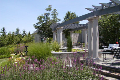Example of a backyard stone patio fountain design in Cincinnati