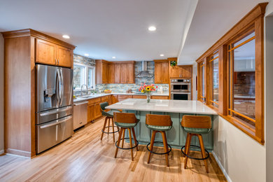 Large elegant light wood floor kitchen photo in DC Metro with an undermount sink, light wood cabinets, quartzite countertops, multicolored backsplash, ceramic backsplash, stainless steel appliances, an island and white countertops