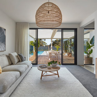 Design ideas for a contemporary family room in Melbourne with white walls, carpet and grey floor.