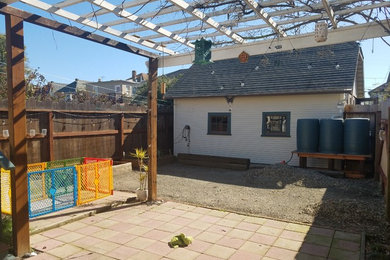 Inspiration for a small shabby-chic style backyard concrete paver patio remodel in San Francisco with an awning