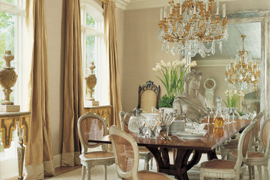 Large elegant medium tone wood floor and brown floor dining room photo in New Orleans with beige walls and no fireplace