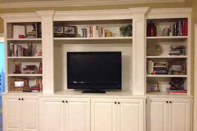 Example of a mid-sized minimalist living room design in Other with a media wall