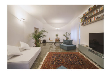 This is an example of an expansive contemporary open plan games room in Florence with a freestanding tv.