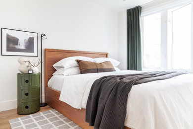 Inspiration for a small scandinavian master vinyl floor and brown floor bedroom remodel in Toronto with white walls