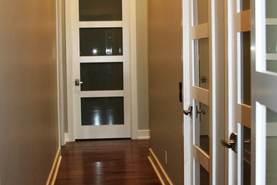 Inspiration for a mid-sized dark wood floor hallway remodel in Austin with beige walls