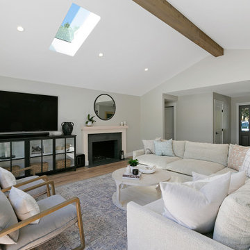 Transitional Living Room Remodel with Exposed Beam and Skylight