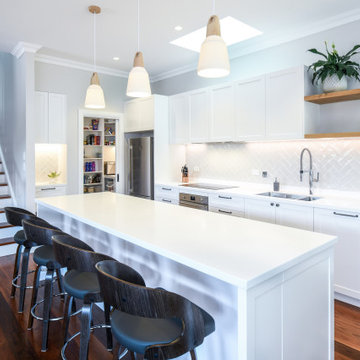 Contemporary white kitchen with timber accents