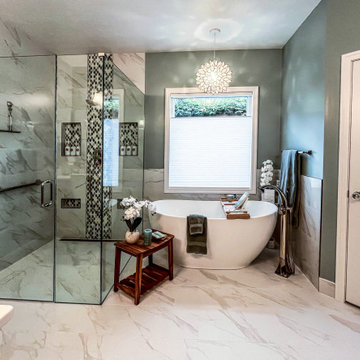 Primary Bath with Marble Look Tiled Shower and Free Standing Tub