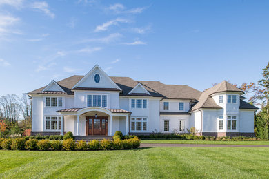 Inspiration for a huge timeless white two-story wood house exterior remodel in New York with a hip roof and a shingle roof