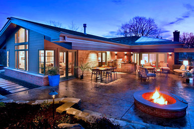 Patio kitchen - large contemporary backyard stamped concrete patio kitchen idea in Other with a roof extension