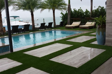 Mid-sized contemporary backyard rectangular pool in Miami with a hot tub and stamped concrete.