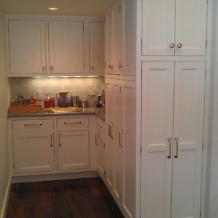 Large farmhouse kitchen pantry photos - Inspiration for a large country u-shaped dark wood floor kitchen pantry remodel in Bridgeport with a farmhouse sink, shaker cabinets, white cabinets, granite countertops, white backsplash, subway tile backsplash, stainless steel appliances and an island