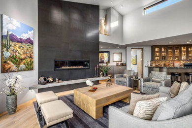 Trendy living room photo in Phoenix with a tile fireplace