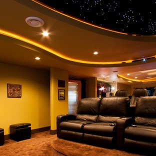 Inspiration for a large classic enclosed home cinema in Vancouver with yellow walls and carpet.