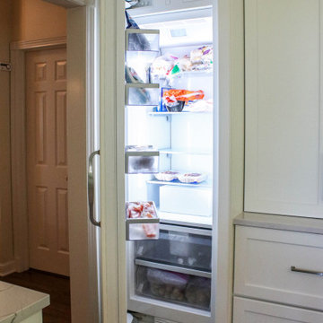White Kitchen with Gray Quartz Countertops, Farmhouse Sink and Hardwood Floors