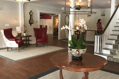 Inspiration for a large transitional dark wood floor and brown floor foyer remodel in Other with gray walls